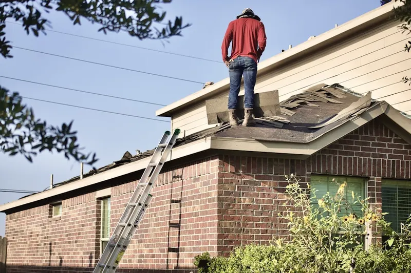 Professional roofer working on a residential roof in Anclote